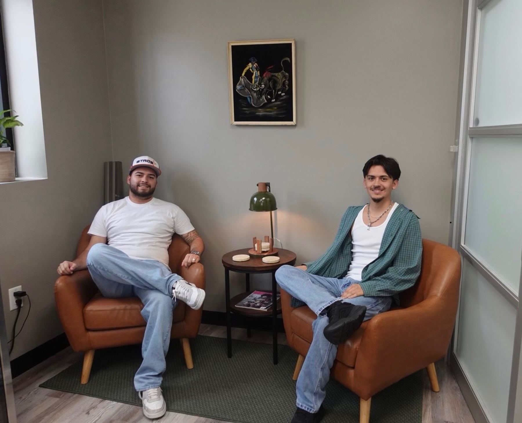 Josh and Edgar, the barbers at Refined Barbers, sitting in the shop's lounge